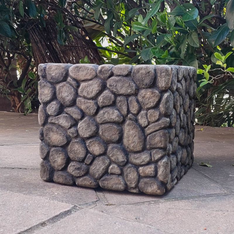 A square box covered in faux pebbles