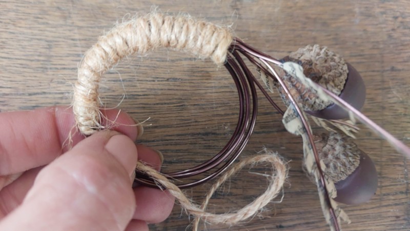Wrap twine around the wire coil to finish off the acorn napkin rings