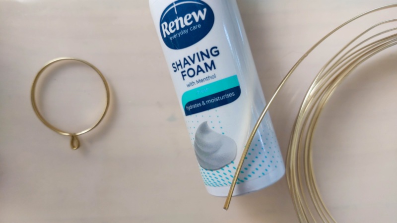 Wrap the flat gold wire around a bottle to form a ring